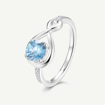 Infinite Embrace promise ring with topaz center stone, silver infinity design and pavé accents